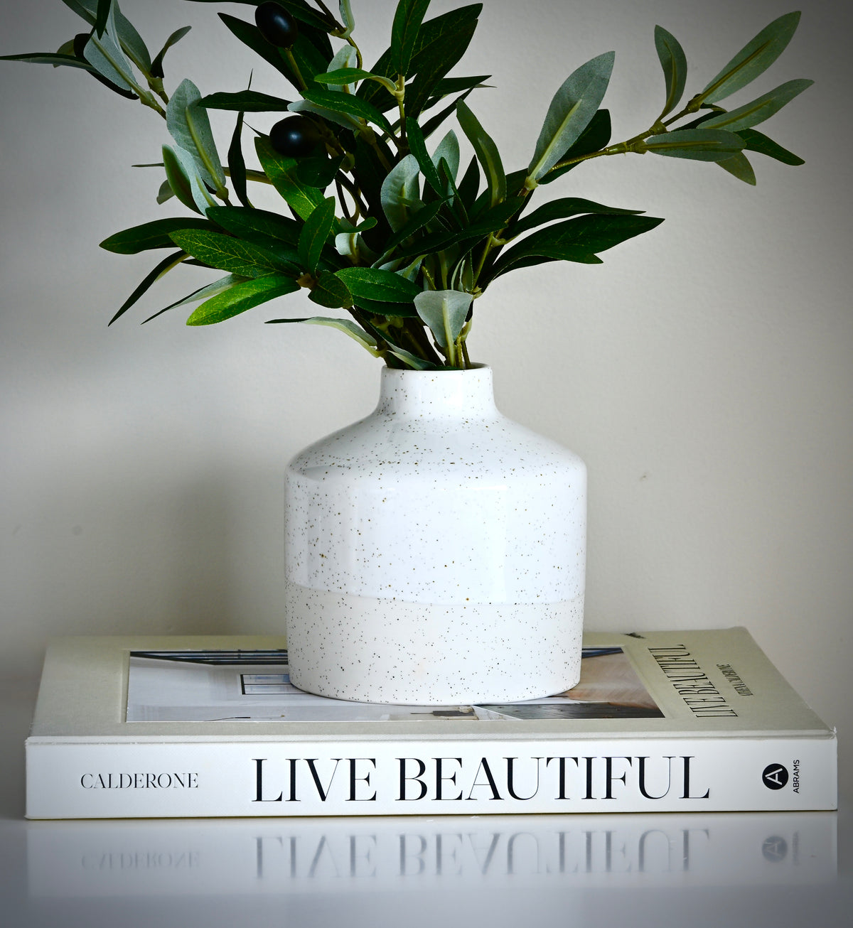 Designer artisan crafted statement piece Diffuser vase in porcelain and part glazed in sandy milky white glaze.